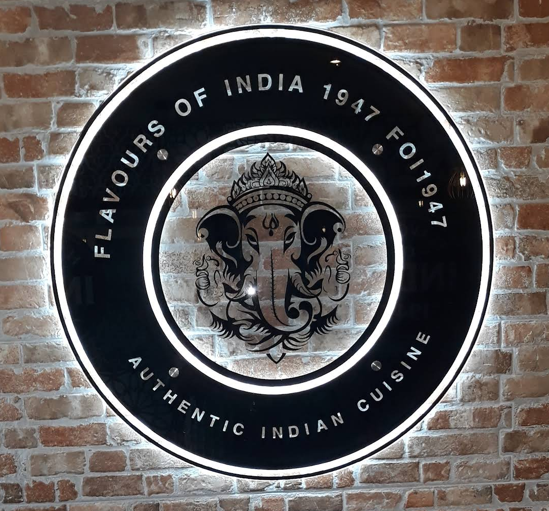 Flavours of India 1947 sign on brick wall